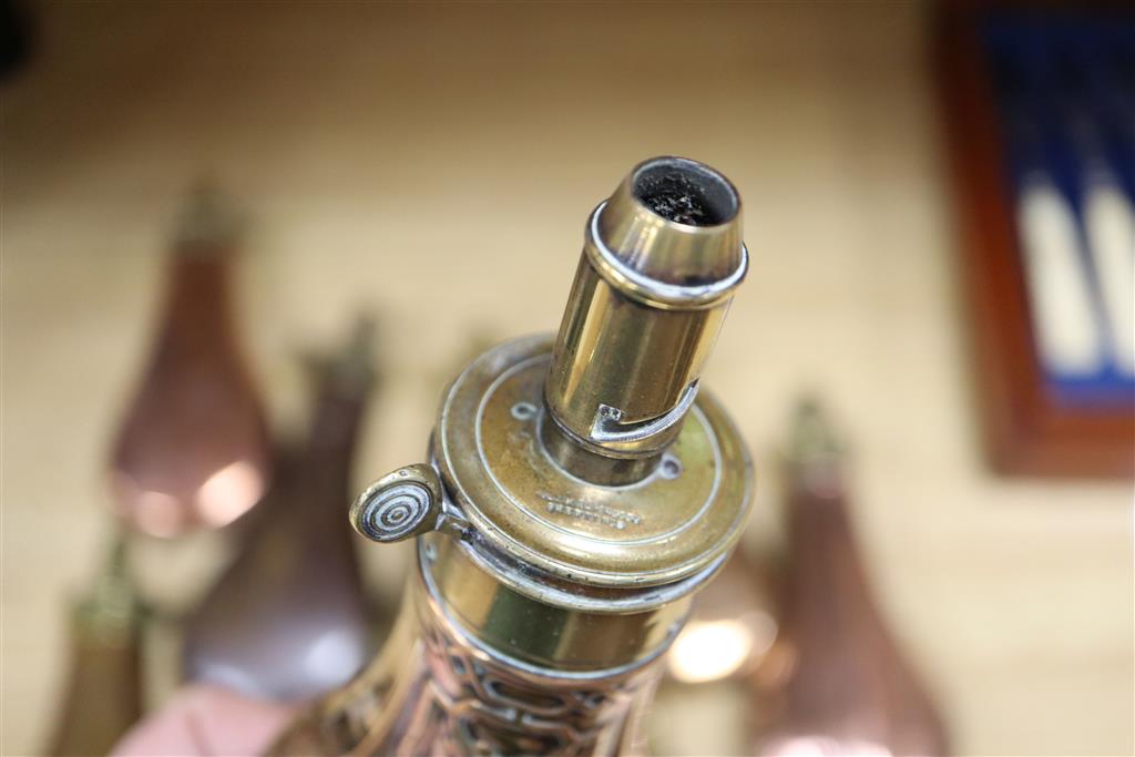 A group of ten Victorian copper / brass powder flasks